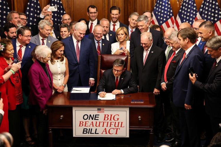 House Speaker Mike Johnson signs President Donald Trump's huge spending and tax measure on Capitol Hill in Washington on July 3, 2025.